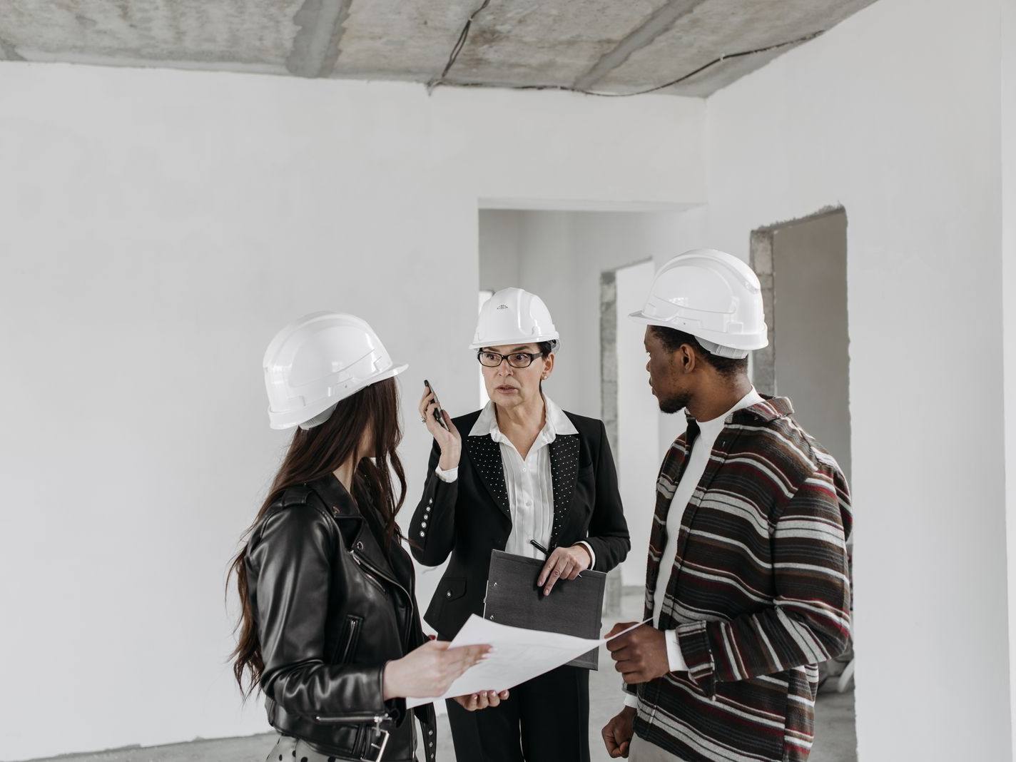Owner's representative reviewing progress with the project team on site